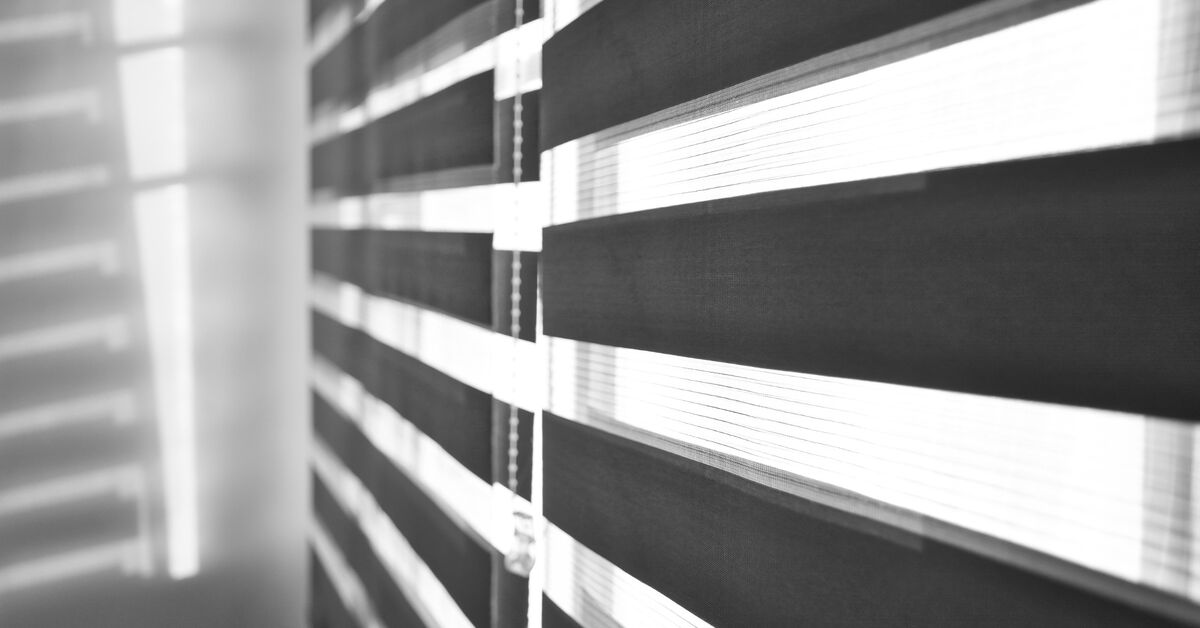 Office window with vertical blinds.